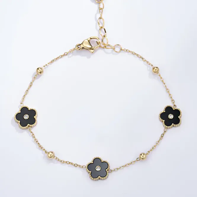 Hovedbilde Gullfarget armbånd med sorte blomster